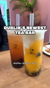 Here are a few options for your alt text, keeping it descriptive and SEO-friendly:

**Option 1 (Descriptive & SEO focused):**
Bubble tea and bubble waffles at Tea Bar Dublin, a new café in Temple Bar offering BOGO deals.

**Option 2 (Action-oriented):**
Customer holding a refreshing boba tea and bubble waffle at the new Tea Bar in Temple Bar, Dublin.

**Option 3 (Concise):**
Refreshing bubble tea and waffles at Tea Bar, a new cafe in the heart of Temple Bar, Dublin.

**SEO Tip:** I included the location (Temple Bar, Dublin) and the product (Bubble tea, waffles) in all options, as these are the high-intent keywords you want Google to index.