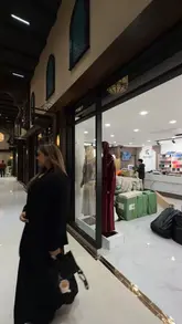 Here are a few options for your SEO alt text (under 125 characters):

*   **Option 1 (Descriptive):** A woman exploring the luxury fashion and jewellery boutiques inside the new Signature Mall in Bradford.
*   **Option 2 (Action-oriented):** Content creator shopping for Eid outfits and jewellery at the newly opened Signature Mall in Bradford.
*   **Option 3 (SEO-focused):** Inside Signature Mall, the UK’s largest Asian shopping mall in Bradford featuring luxury fashion and food stalls.

**Recommendation:** Option 1 is best if the image focuses on the person, while Option 3 is best if the image focuses on the mall environment.