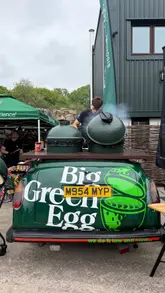 A montage video capturing a BBQ festival event featuring various outdoor cooking brands and live demonstrations. The video showcases crowds, cooking setups, and finished BBQ dishes like ribs and steak.