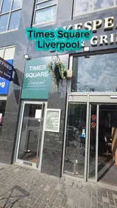 Here are a few options for your SEO alt text, keeping under the 125-character limit:

**Option 1 (Focus on atmosphere & location):**
The interior of Times Square restaurant in Liverpool, overlooking St John's Beacon from Williamson Square.

**Option 2 (Focus on the venue features):**
Spacious Times Square venue in Liverpool featuring a large screen for sports and views of St John's Beacon.

**Option 3 (Concise & descriptive):**
A bright, spacious interior at Times Square, a hidden gem restaurant located in Liverpool’s Williamson Square.

**Recommendation:** Use **Option 1** if the image focuses on the view/vibe, or **Option 2** if the image shows the TV screen/seating area.