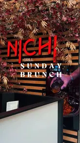 Here are a few options for your SEO alt text, depending on what the image shows:

**Option 1 (Focus on the food spread - best for a flat-lay):**
Delicious variety of Japanese dishes, sushi, and ramen from the new menu at NICHI Grill in The Trafford Centre.

**Option 2 (Focus on the restaurant setting):**
A table full of fresh sushi, noodles, and rotisserie chicken at NICHI Grill, located in The Orient at Trafford Centre.

**Option 3 (Short & punchy):**
Selection of sushi, ramen, and Asian fusion dishes at NICHI Grill restaurant in Manchester's Trafford Centre. 

**SEO Tip:** If the image features a specific item (like the sushi or the chicken), use the option that mentions that dish first to help your image rank for those specific keywords!