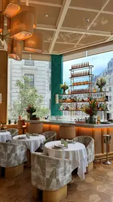 Here are a few SEO-friendly alt text options, depending on the specific focus of the image:

**Option 1 (Best for general SEO):**
Delicious Riviera Seabass and cocktails at Riviera London restaurant, an elegant French-inspired dining spot.

**Option 2 (Focus on atmosphere):**
Elegant interior and Mediterranean-inspired dining at Riviera London, a French Riviera-style restaurant.

**Option 3 (Focus on the food - if the image is a table spread):**
A beautiful spread of Mediterranean food and cocktails at the chic Riviera London restaurant.

**Tip:** Choose the one that best describes what is actually visible in the photo!