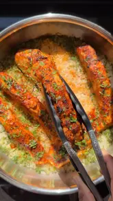 Here are a few options for your SEO alt text, depending on the focus of your image:

**Option 1 (Focus on the dish - Best for SEO):**
One-pan Thai curry salmon served with creamy coconut rice in a white bowl.

**Option 2 (Descriptive & appetizing):**
Freshly cooked Thai curry salmon topped with herbs and lime, served with a side of fluffy coconut rice.

**Option 3 (Brand/Recipe focus):**
Dinner Time cookbook recipe: A vibrant one-pan Thai curry salmon dish with coconut rice.

**SEO Tip:** I recommend **Option 1** as it includes the primary dish name and the key ingredients, which are the terms users are most likely to search for.