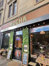 To provide the most accurate alt text, it would be helpful to know which specific food or venue is in the photo. Assuming it is a general food shot from one of the tagged locations, here are a few options:

**Option 1 (If showing a specific dish):**
"A delicious meal at a restaurant in Glasgow visited during a food tour of the city." (79 characters)

**Option 2 (If showing the market/group):**
"Enjoying authentic food and culture at the Hong Kong market at The Barras Market in Glasgow." (91 characters)

**Option 3 (SEO-focused/General):**
"A table full of food at a top-rated Glasgow restaurant featuring local Scottish dining recommendations." (101 characters)

**Tip for best SEO:** Replace the word "restaurant" with the specific name of the place (e.g., "Dimaggios") if that is what the image shows.