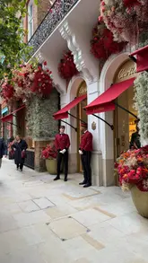 A montage video showcasing various elaborate floral installations across Chelsea, London, as part of the Chelsea in Bloom event. The video features creative displays including space-themed sculptures, animals, and artistic arrangements outside luxury storefronts.