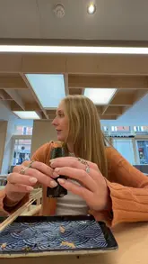 A creator visits a new sushi handroll bar in Soho, London, reviewing several dishes including various handrolls, scallop crudo, akami crudo, and A5 wagyu nigiri.