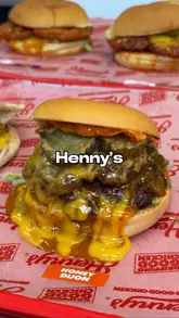 A promotional video for Henny's in Blackburn, featuring a variety of their fried chicken dishes, including burgers, pitas, wings, tenders, loaded fries, and desserts. The video uses a fast-paced editing style with voiceover commentary to highlight the signature sauces and indulgent nature of the food.