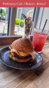A montage video showcasing the brunch menu, coffee, and baked goods at Pinkmans Cafe + Bakery, highlighting items like the Crobun stack, smoked salmon toast, and their signature sourdoughnuts.