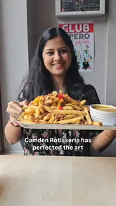 A creator visits Camden Rotisserie to review their comfort food offerings, including a spice bag, half chicken with mash and gravy, a southern fried chicken burger, and sticky toffee pudding.