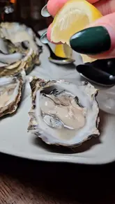 A fast-paced, music-synced reel showcasing a variety of seafood dishes, cocktails, and desserts at a Burger & Lobster location in London. The video features the creator interacting with the food and drinks, providing a dynamic look at the dining experience.