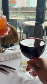 A short, music-led montage showcasing a Sunday lunch experience at Riverstation in Bristol, featuring close-ups of drinks, starters like pate and tomatoes, and a hearty Sunday roast with cauliflower cheese, set against a waterside backdrop.