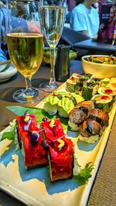 Here are a few SEO-friendly alt text options for your image:

**Option 1 (Descriptive & SEO focused):**
Vegan sushi and vegetable sticks served at the Sticks’n’Sushi bottomless brunch in Manchester.

**Option 2 (Action-oriented):**
A table full of plant-based sushi, grilled skewers, and drinks at Sticks’n’Sushi Manchester.

**Option 3 (Concise):**
Platter of vegan Japanese sushi and grilled vegetable skewers from Sticks’n’Sushi restaurant in Manchester.

**Tip:** Choose the one that best matches the specific food shown in your photo!