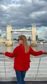 Here are a few options for your SEO alt text, depending on what is visible in your specific image:

**Option 1 (Focus on the ship/Tower Bridge):**
"Windstar’s Star Pride cruise ship sailing past Tower Bridge in London at night."

**Option 2 (Focus on the departure/location):**
"View of Windstar cruise ship docked next to HMS Belfast in central London before departure."

**Option 3 (Focus on the travel experience):**
"The Star Pride cruise ship sailing through London under Tower Bridge at night."

**SEO Tip:** I recommend **Option 1**, as it includes the primary subject (the ship name) and the iconic location (Tower Bridge), both of which are high-value search terms for travel content.