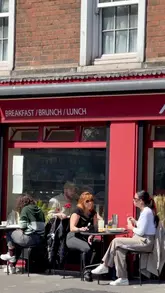 Here are a few options for your SEO alt text, keeping it under 125 characters:

*   **Option 1 (Descriptive):** People relaxing in a sun-drenched Dublin park with takeaway coffee on a rare sunny day in Ireland.
*   **Option 2 (Focus on atmosphere):** Dubliners enjoying a sunny day outdoors at a city park with coffees, celebrating the rare blue skies.
*   **Option 3 (Concise):** A sunny day in a Dublin park with people sitting on the grass drinking coffee.