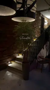 Here are a few options for your SEO alt text, depending on the specific focus of the image:

**Option 1 (Focus on atmosphere):**
Atmospheric interior of Mitsu restaurant in Shoreditch with guests enjoying sushi and cocktails.

**Option 2 (Focus on the food):**
Fresh sashimi and tempura served on a table at Mitsu, a cozy Japanese restaurant in Shoreditch.

**Option 3 (General):**
Diners enjoying sushi and drinks in the cozy, low-lit dining room of Mitsu restaurant in Shoreditch.

**SEO Tip:** I recommend **Option 1 or 3** as they capture both the location (Shoreditch) and the restaurant name (Mitsu), which are the two most important elements for search visibility.