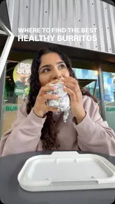 Here are a few options for your SEO alt text (all under 125 characters):

**Option 1 (Descriptive):**
A spinach wrap power burrito with Mexican herb chicken, fresh vegetables, and guacamole from Zambrero in Birmingham.

**Option 2 (Action-oriented):**
Close-up of a healthy, protein-packed chicken burrito from Zambrero at the Bullring shopping centre in Birmingham.

**Option 3 (Keyword-focused):**
Healthy halal Mexican herb chicken burrito from Zambrero restaurant at the Bullring in Birmingham.

**SEO Tip:** Option 1 is generally the best for accessibility, as it clearly describes exactly what is in the photo.