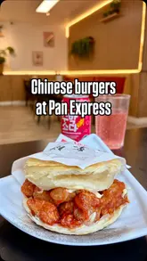 Here are a few options for your alt text, depending on how descriptive you want to be:

**Option 1 (Focus on the food):**
Close-up of a crispy honey chicken Chinese burger from Pan Express Birmingham served on a wooden board.

**Option 2 (Descriptive and SEO-friendly):**
Crispy honey chicken burger from the newly reopened Pan Express restaurant at the Mailbox in Birmingham.

**Option 3 (Short and punchy):**
Delicious crispy honey chicken Chinese burger served at Pan Express Birmingham.

**SEO Tip:** I included "Pan Express Birmingham" and "Chinese burger" as these are the high-value keywords for your post.