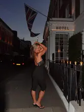 A lifestyle-focused social media post featuring a woman posing outside a hotel in Marylebone at night, intended to showcase the venue as a destination for a night out.