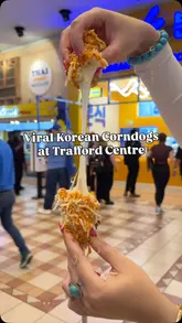 Here are a few options for your alt text, depending on the specific image content:

**Option 1 (Focus on the food):**
Delicious Korean mozzarella corndogs and fried chicken served at the new Bunsik shop in The Trafford Centre.

**Option 2 (Focus on the location/brand):**
Bunsik Korean street food kiosk at The Trafford Centre featuring crispy corndogs, tteokbokki, and fried chicken.

**Option 3 (Short & punchy):**
Close-up of crispy Korean corndogs and fried chicken from the new Bunsik store at The Trafford Centre.

**SEO Tip:** The best alt text is descriptive enough for a screen reader user to visualize the photo while including your primary keywords (Bunsik, Korean corndogs, Trafford Centre).