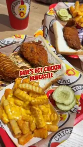 A vlog-style review of the new Dave's Hot Chicken location in Newcastle, showcasing the menu, interior, and food items like tenders, sliders, cheese fries, and a milkshake.