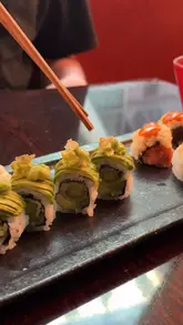 A montage-style video showcasing the interior, food, and drinks at Sexy Fish Manchester. The video features shots of the restaurant's decor, the menu, various dishes including sushi and salmon, and cocktails, set to music.