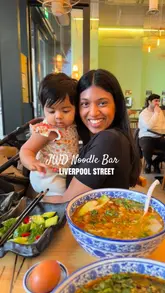 A short, engaging video review of JWD Noodle Bar in Liverpool Street, London. The video features the creator and their child, highlighting the fresh hand-pulled noodle process, the restaurant's interior, and a variety of dishes including noodle soup and skewers.