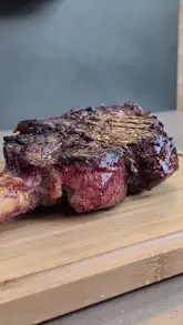A product demonstration video featuring the unboxing, assembly, and use of a Napoleon BBQ grill to cook a tomahawk steak and potatoes.
