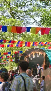 A fast-paced, energetic montage capturing the atmosphere of the Bearded Theory festival, featuring live music, family-friendly activities, and festival food.