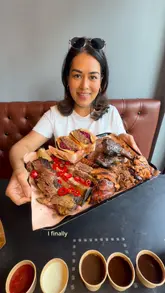 A review of Billy's Smokehouse in West London, highlighting their Texas-style BBQ offerings including beef short ribs, brisket, and a pulled beef sandwich. The video features the creator trying the food and showing the cooking process.