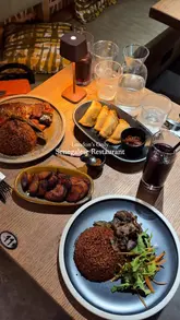 A visually appealing montage showcasing a variety of Senegalese dishes, including rice, fish, plantains, and desserts, served at a restaurant in London. The video focuses on close-up shots of the food being plated and prepared, highlighting the textures and presentation of the meal.