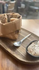 A montage of an outdoor restaurant terrace, featuring shots of the menu, cocktails, beer, bread, tacos, croquettes, and steak, set to music.