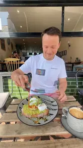 A review of Ren's Kitchen in Eastbourne, featuring a tour of the cafe, a look at the cake display, and a review of the poached eggs and avocado on sourdough breakfast.