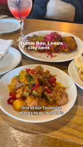 A family-focused review of a Turtle Bay restaurant, showcasing the kid-friendly amenities, cocktail menu, and a variety of Caribbean-inspired dishes including jerk chicken, chilli squid, and steak.