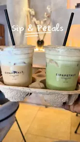 A vlog-style review of a cafe featuring their viral banana pudding matcha and tiramisu latte. The creator discusses the aesthetic appeal, the taste, and the practical difficulty of consuming the drinks due to the dessert toppings.