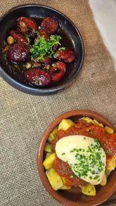 A promotional video for a Spanish tapas night at Springfield Events Hall, featuring shots of the venue's interior, table settings, and a variety of tapas dishes including patatas bravas, chorizo, meatballs, and sangria.