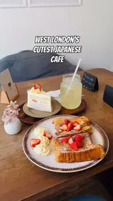 A short, aesthetic video showcasing the food and interior of Mitsuba London, a Japanese cafe. The video features close-ups of French toast, strawberry cake, and lychee iced tea, alongside shots of the cafe's cozy decor and plush toys.