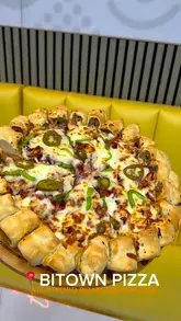 A promotional video for Bitown Pizza in Birmingham, featuring shots of the restaurant exterior, interior, and the preparation of their signature pizzas. The video highlights the fresh ingredients and the variety of pizza options available.