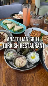 A promotional video for Anatolian Grill in Prestwich, Manchester, featuring a montage of the restaurant's interior, cocktail bar, and various Turkish dishes including mezze, mixed grill, and baklava.