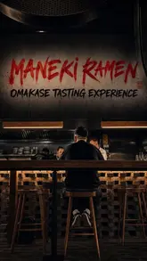 A moody, atmospheric shot of a diner at a counter during an omakase tasting experience at Maneki Ramen, emphasizing the venue's intimate and exclusive vibe.