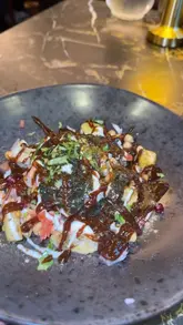 A promotional montage for a new restaurant called Indara in Rochdale, featuring shots of various dishes including curries, burgers, and skewers, alongside interior shots of the dining area.