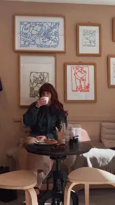 A short, aesthetic montage showcasing the interior and offerings of a coffee shop called Traade, featuring shots of the exterior, menu, coffee preparation, and a pastry.