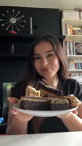 The creator reviews a selection of vegan desserts purchased at a local vegan festival in Kent, providing commentary on the taste and texture of each item.