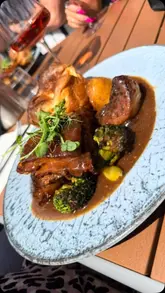 A montage-style video showcasing the exterior, interior, and food offerings of an Italian restaurant, Vino & Pane. The video highlights the Sunday roast menu, outdoor seating area, and general dining atmosphere.