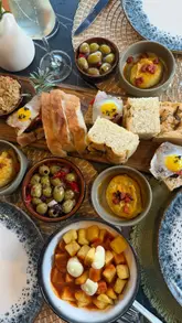 A review of a bottomless brunch experience at Pugh's Garden Kitchen in Abergavenny, featuring a variety of Spanish-inspired tapas dishes and free-flowing drinks in a bright, garden-themed setting.