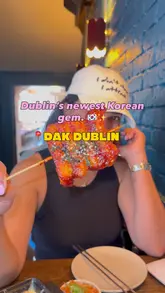 A fast-paced, energetic review of Dak Dublin, a Korean restaurant. The video features a variety of dishes including Korean fried chicken, corn cheese, tteok skewers, and desserts, alongside drinks like somak. The creator showcases the venue's interior and shares their positive experience.