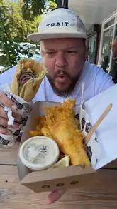 A high-energy video review of Clopton Catch in Stratford-upon-Avon, featuring the creator visiting the venue, showing the kitchen preparation process, and tasting the fish and chips and chicken wrap.