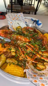 A promotional video for 'Rock & Scallop' featuring their signature seafood boil. The video showcases the preparation and presentation of the large platter, the creator enjoying the meal, and shots of the venue's interior and exterior at Newport Market and Albert Hall, Swansea.