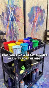 A short, energetic video showcasing a 'Splash Art' experience in Birmingham. It features clips of people wearing protective gear, throwing paint at canvases, and displaying their finished artwork, highlighting it as a fun activity for families and friends.