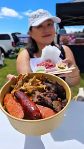 A creator visits a local food festival, showcasing various street food vendors, including a BBQ smokehouse, a Nigerian food stall, and a matcha drink stand. The video highlights the atmosphere, the food preparation, and the creator's reactions to the dishes.