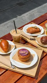 A promotional reel for a new London bakery, Rise & Fold, highlighting their fusion of European pastry techniques with Asian flavours, specifically showcasing their salt bread and various pastries, while promoting a limited-time £1 coffee/matcha deal.